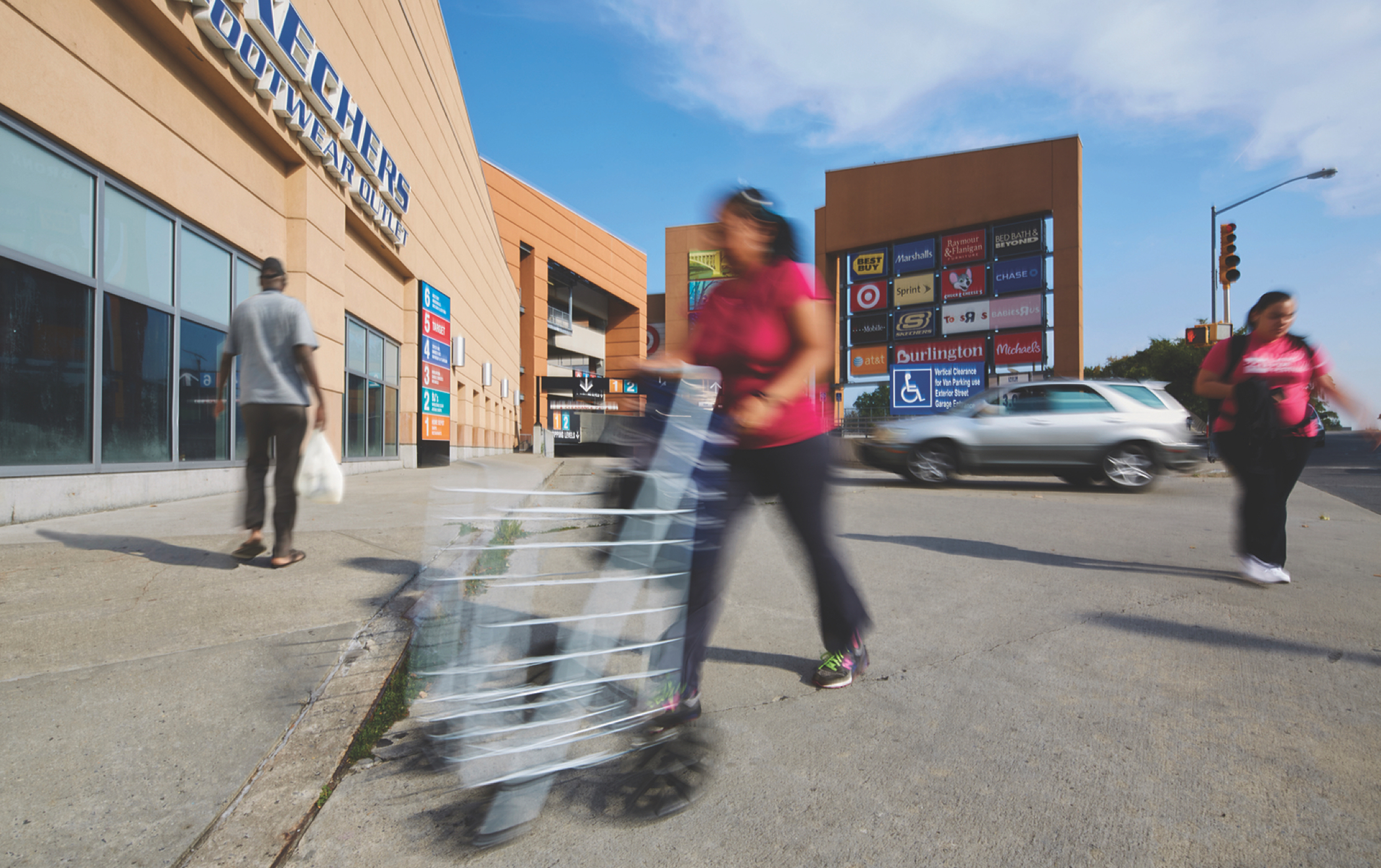 Shoppers in motion outside the Bronx Terminal Market entrance.