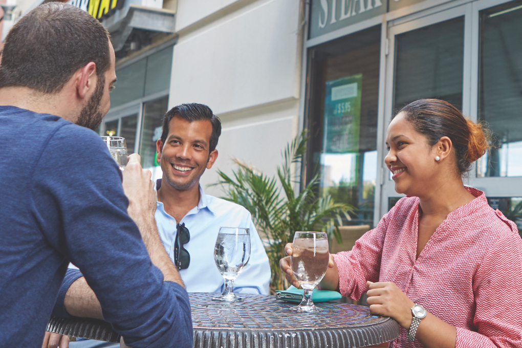 Three shoppers take a break in the  Bronx Terminal Market food court.