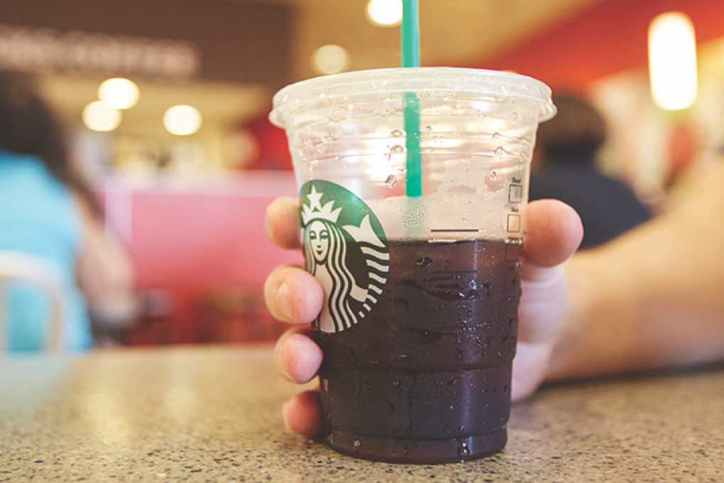 Close up a iced coffee cup on a table in the the Bronx Terminal Market.