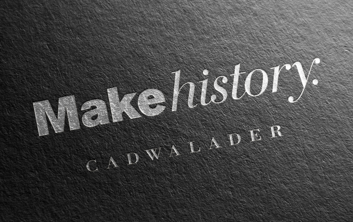 Close up of the text, Make history and the Cadwalader logo type embossed in silver on a textured book cover.