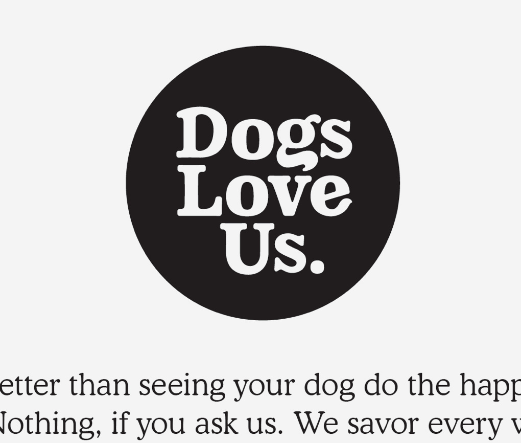 Close up of Dogs Love Us logo with white typed dropped out in a black circle.