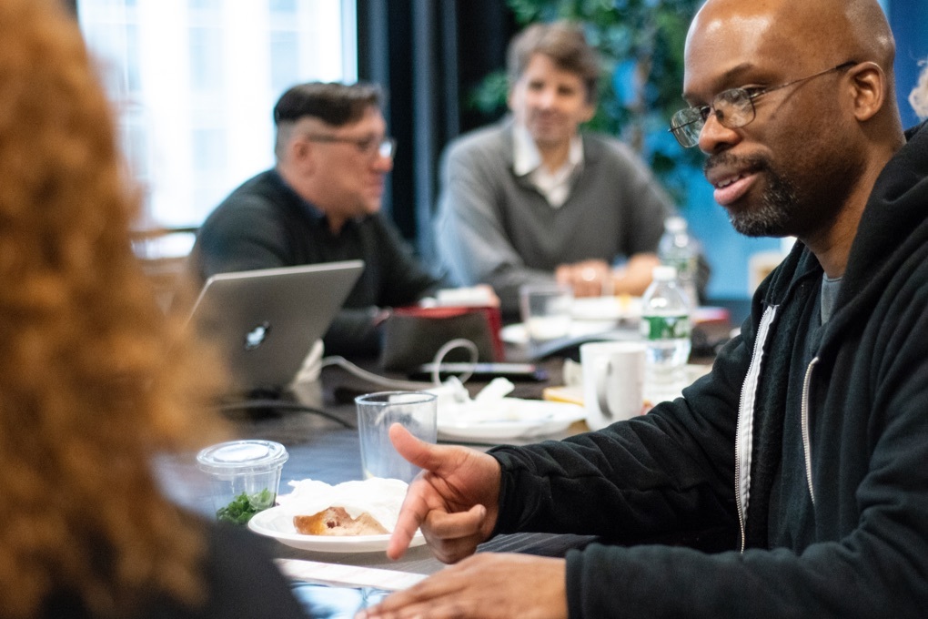 James Otis Smith, one of the illustrators for Instinet's Fintech at Fifty graphic novel. conferring with the other artists.