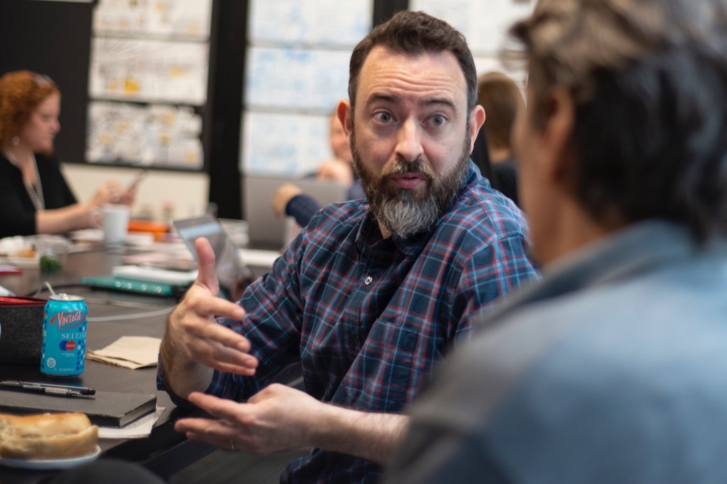 Owen Brozman, one of the illustrators for Instinet's Fintech at Fifty graphic novel. conferring with the other artists.