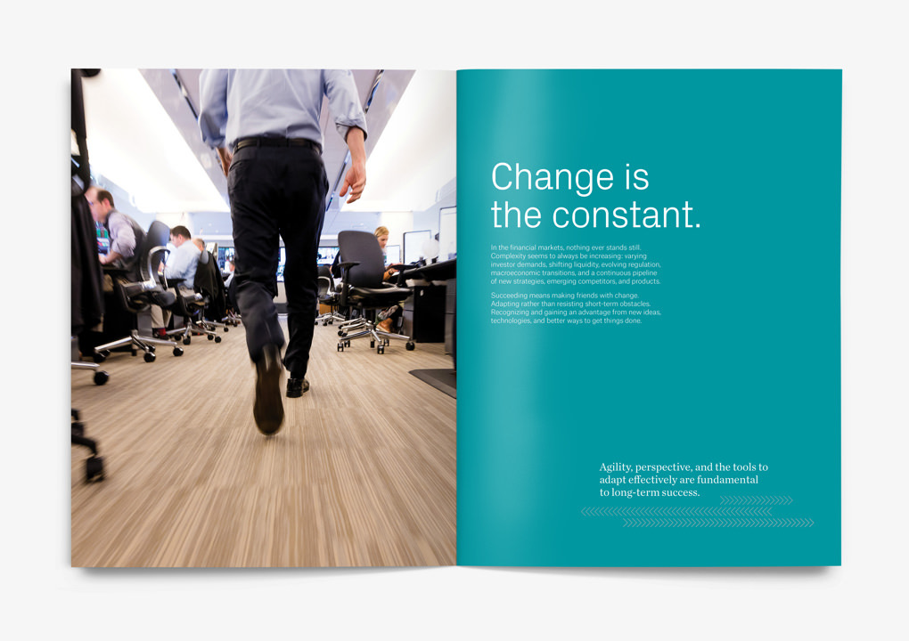 An employee hurries through the Instinet office, moving quickly away from the camera across a light wooden floor.