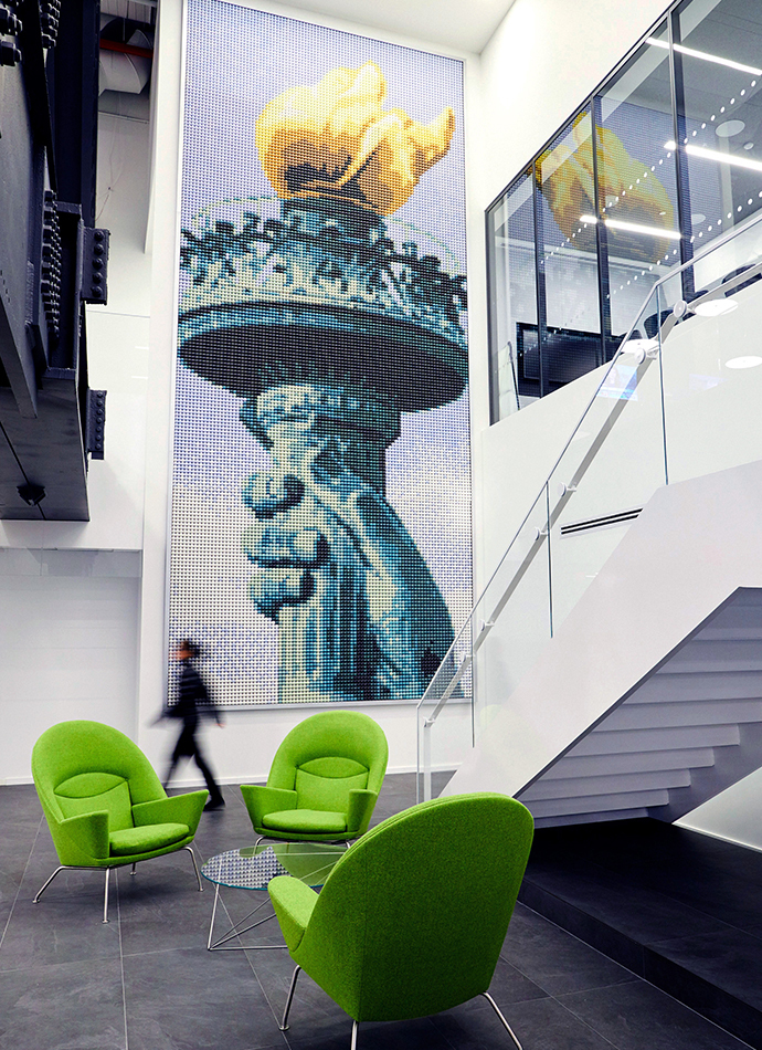 Life size KCG office mural of the torch of the Statue of Liberty made entirely of ping pong balls.