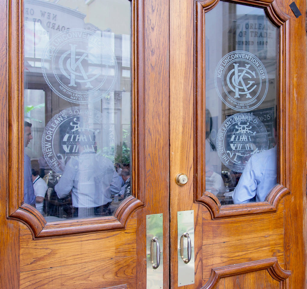 2015 KCG Uncon client event conference entryway; event logos adorn the glass panels of the doors.