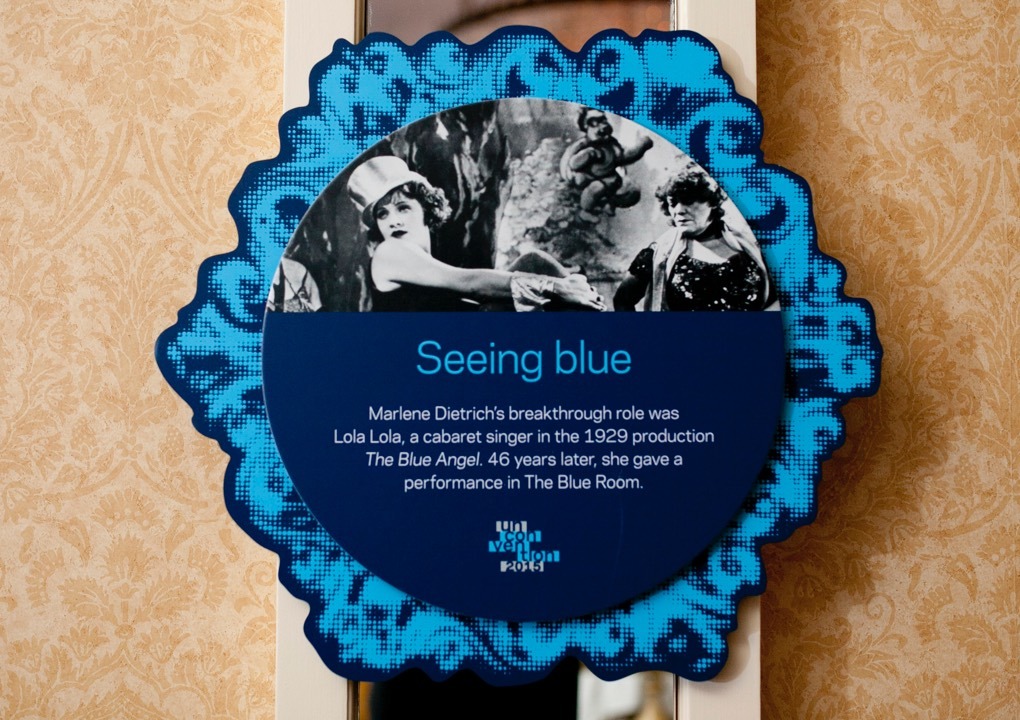 KCG Uncon event wall hanging with words "Seeing blue," other text, and a film still picture of the actress Marlene Dietrich.