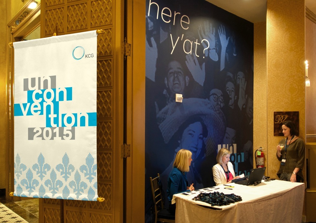 2015 KCG Uncon client event registration table with conference banners on the walls.