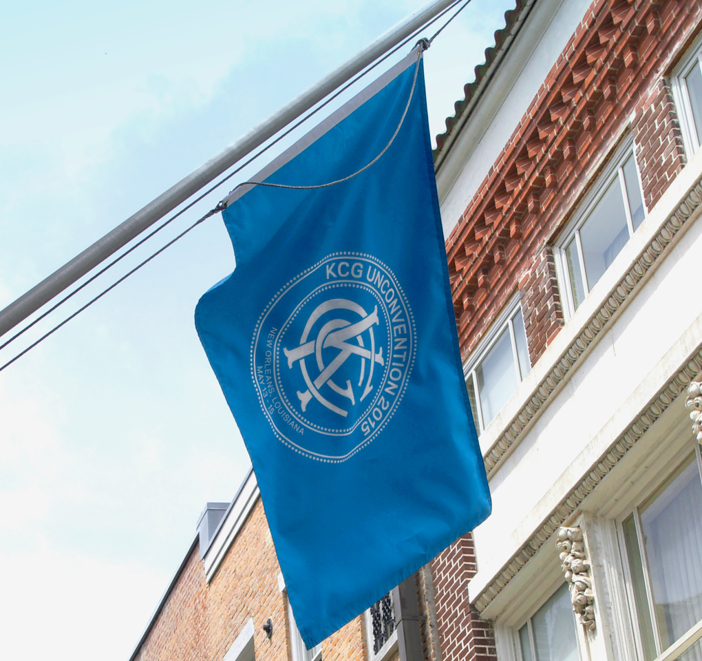 A large blue flag with the 2015 KCG Uncon client event logo flies outside the conference facilities.