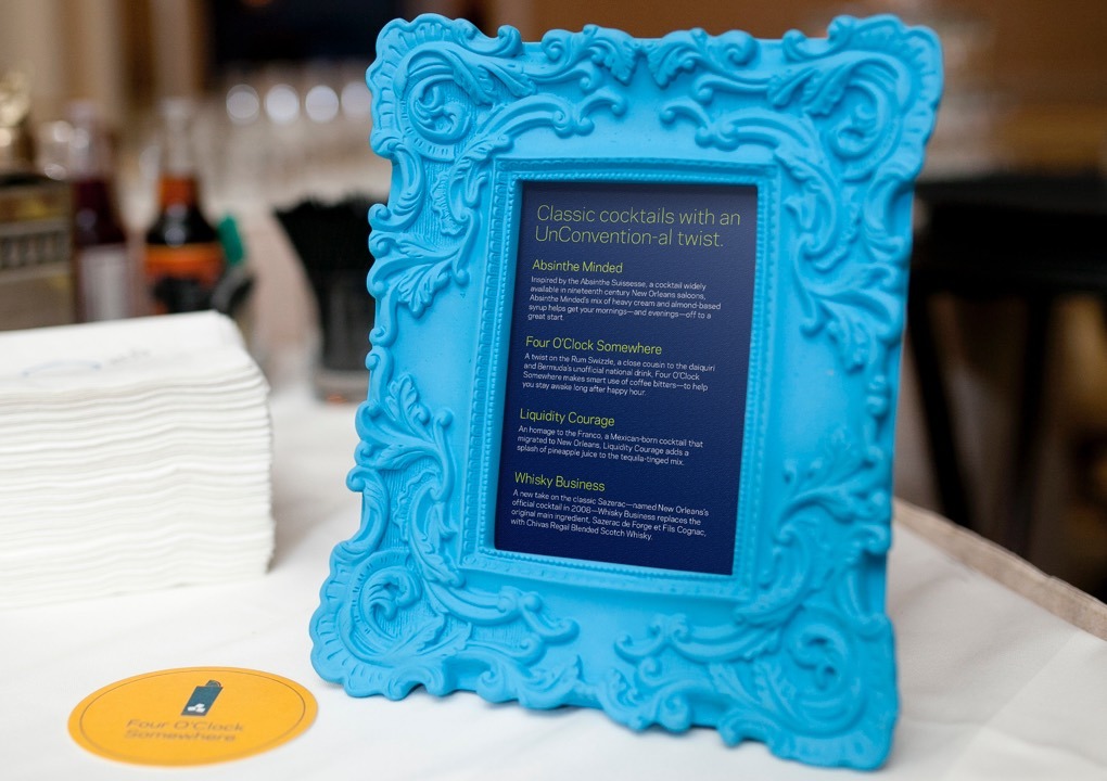 2015 KCG Uncon client event dinner menu card in am ornate blue table-top frame.