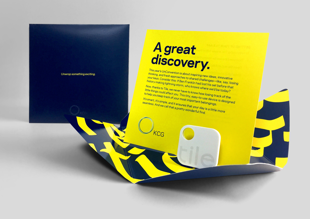 An open package for a giveaway item at the 2016 KCG Uncon client event with the headline "A great discovery."