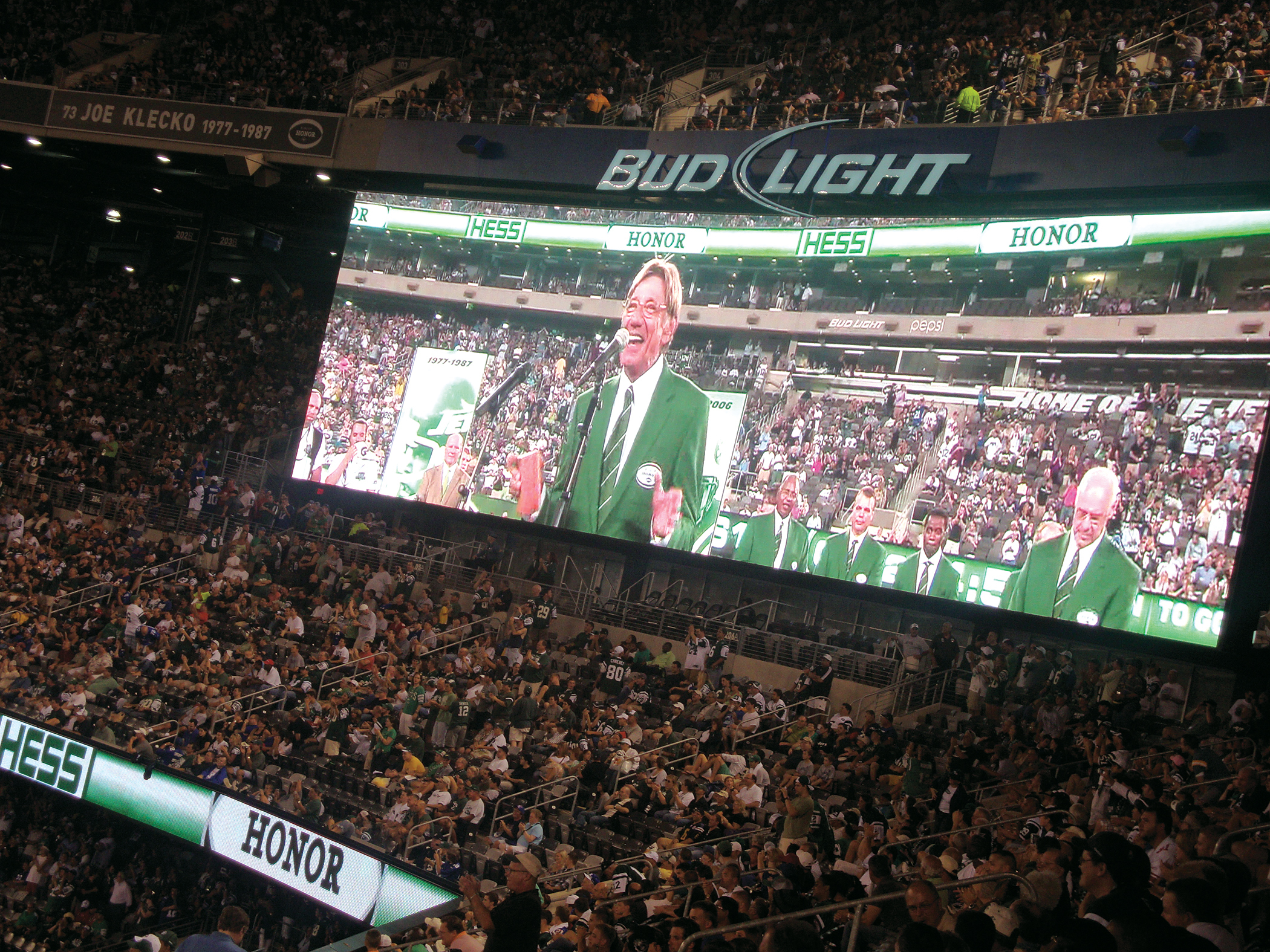 A huge crowd of New York Jets fans cheering at MetLife Stadium.