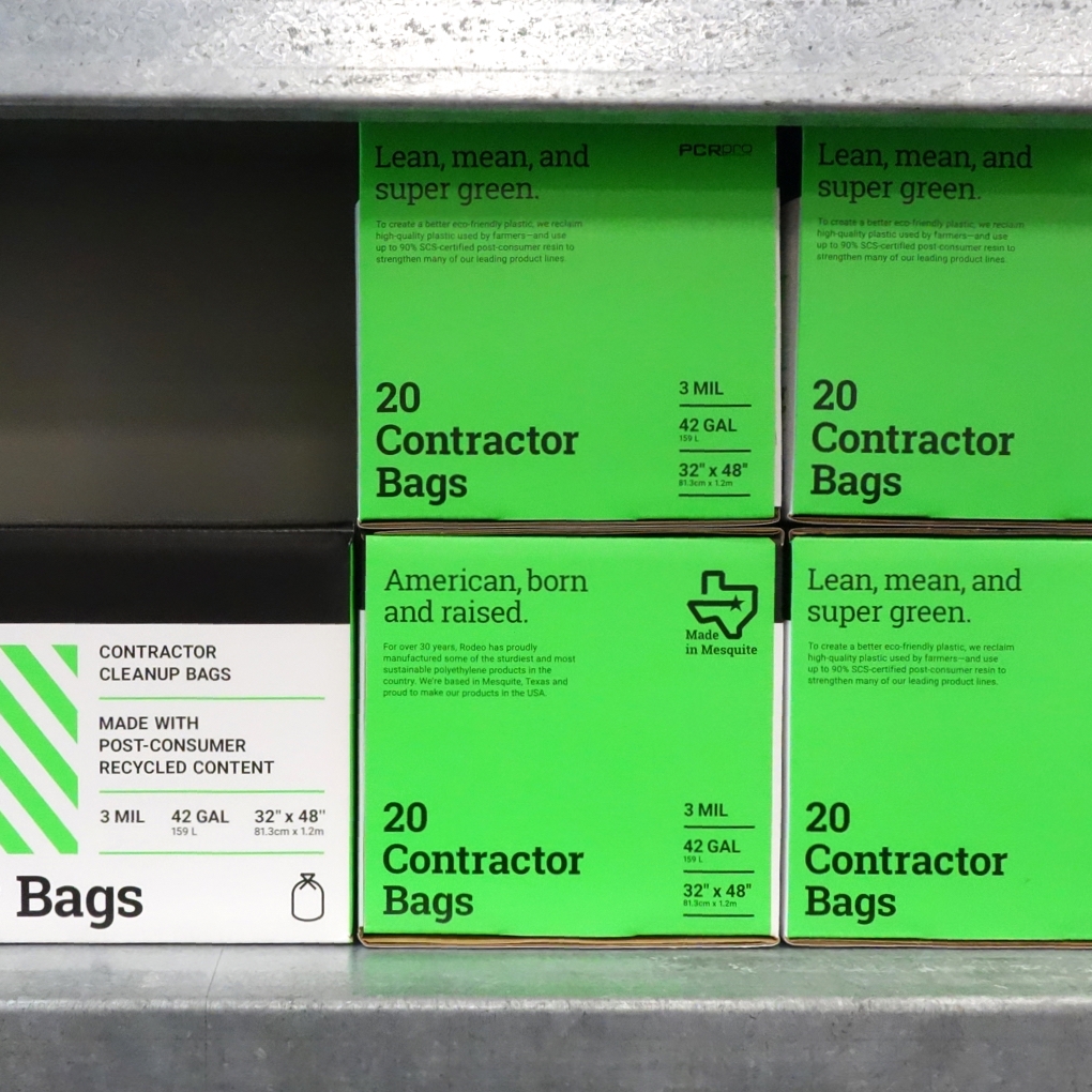 A stack of Rodeo Plastics 20 contractor bag packages imprinted with the phrase "American born and raised."