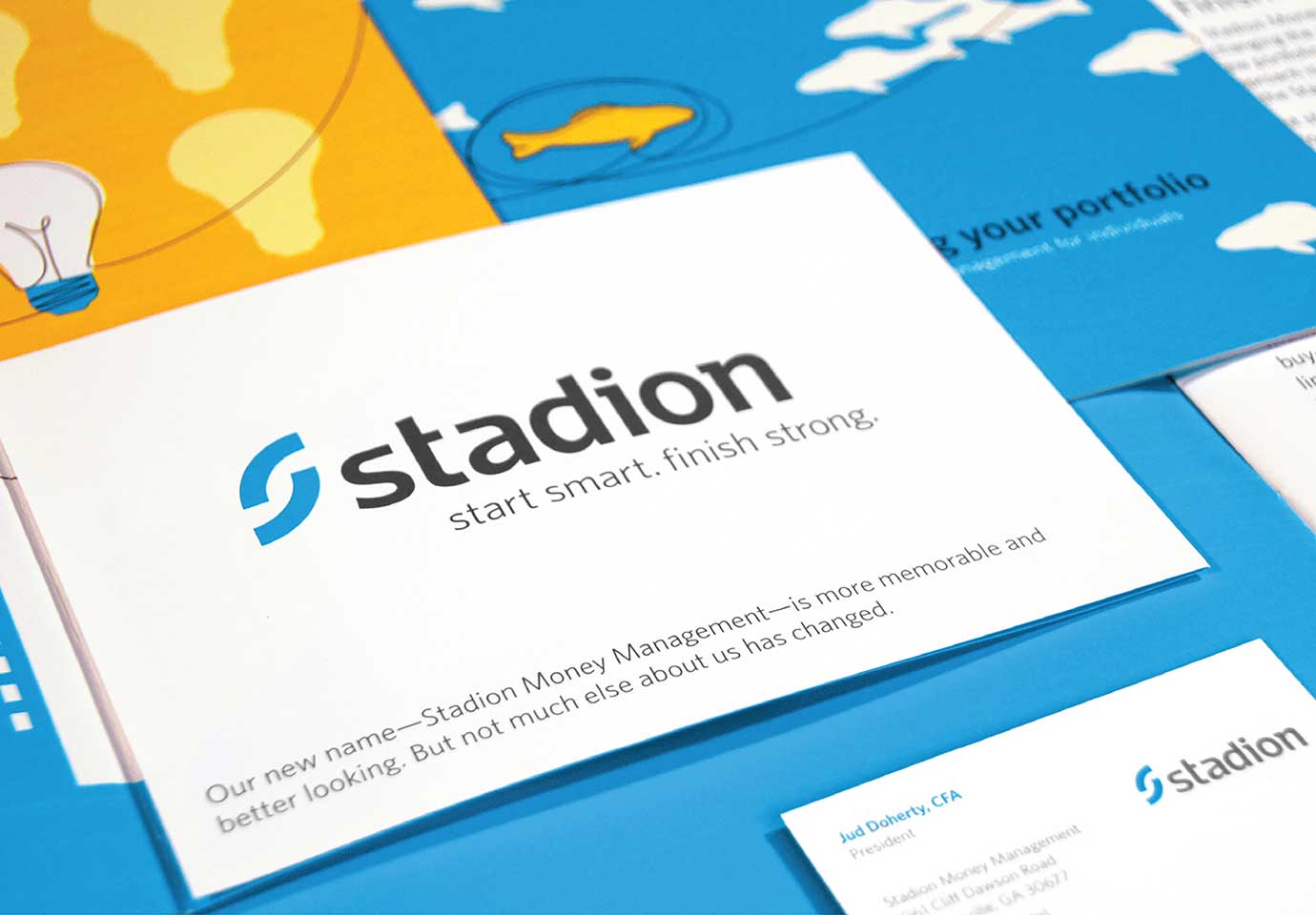 Stadion illustrated brand materials laid out on a table featuring the logo and the tagline "Start smart, finish strong."