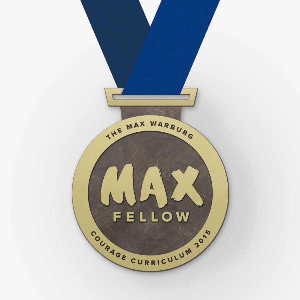 Close up of the Max Courage "Max Fellow" award medallion on a blue lanyard.