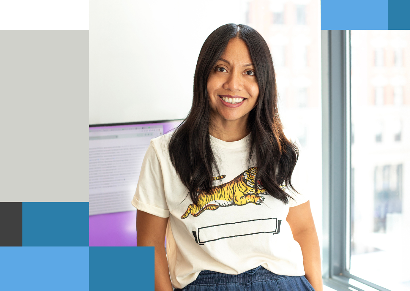 Thinkso creative director Shelley Batuyong, a brown-haired Filipino woman in a t-shirt with a tiger on it, smiles at the camera.