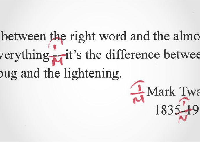 A paragraph marked up with proofreading edits in red ink.