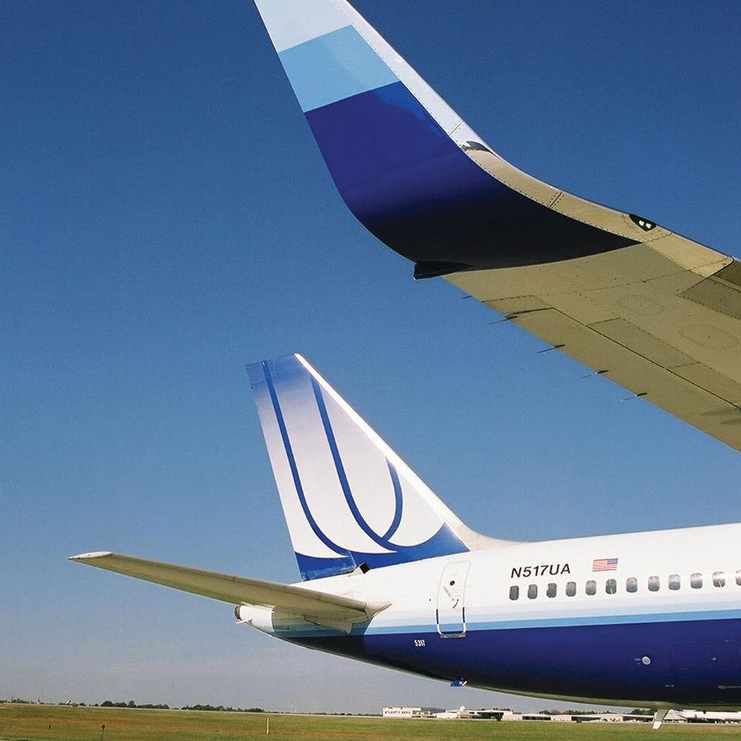 Wing and tail artwork on a taxiing United Airlines aircraft.