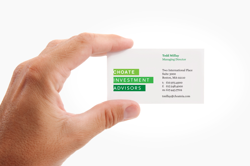 Close up of a hand holding a Choate Investment Advisors business card, with its white type on stacked green bars logo.