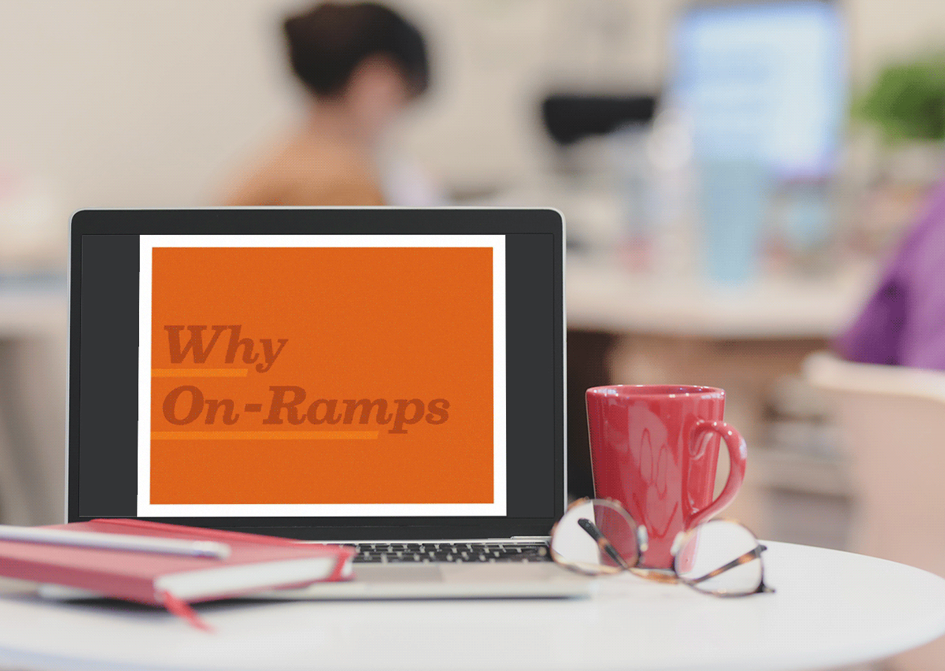 Laptop with an animated screen showing various pages from the On-Ramps proposal template.