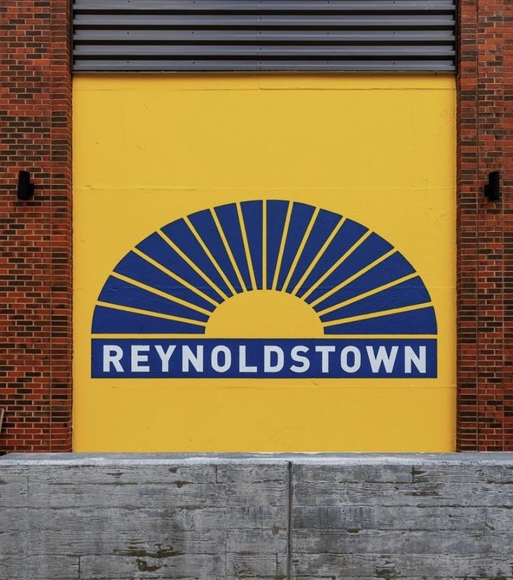 Mural of a graphic sunburst with the work "Reynoldstown" painted underneath