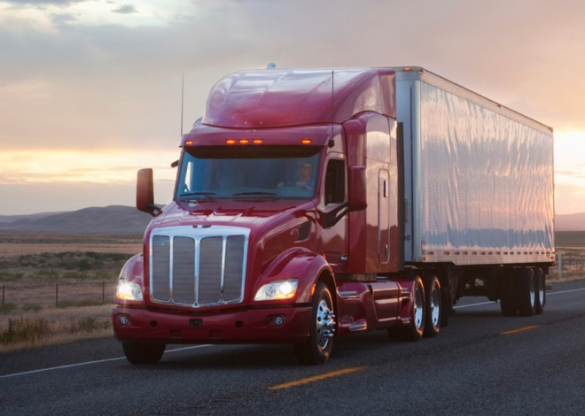 Image of a red track trailer on a desert highway